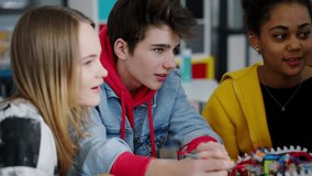 Group of high school students building and programming electric toys and robots at robotics classroom - Powered by Shutterstock - Get 15% off with code: PIKWIZARD15