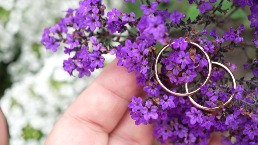 Wedding rings on small purple flower