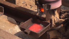 Closeup of molten steel for a railroad track. Slow motion clip.