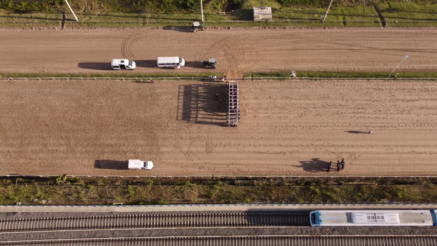 Horse race starts in Palermo racecourse in Buenos Aires. Aerial top down view in 4K