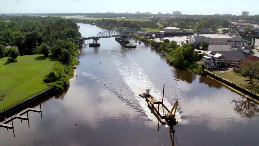 Boat passes under side bridge along intracoastal waterway in north myrtle beach sc, south carolina near barefoot landing