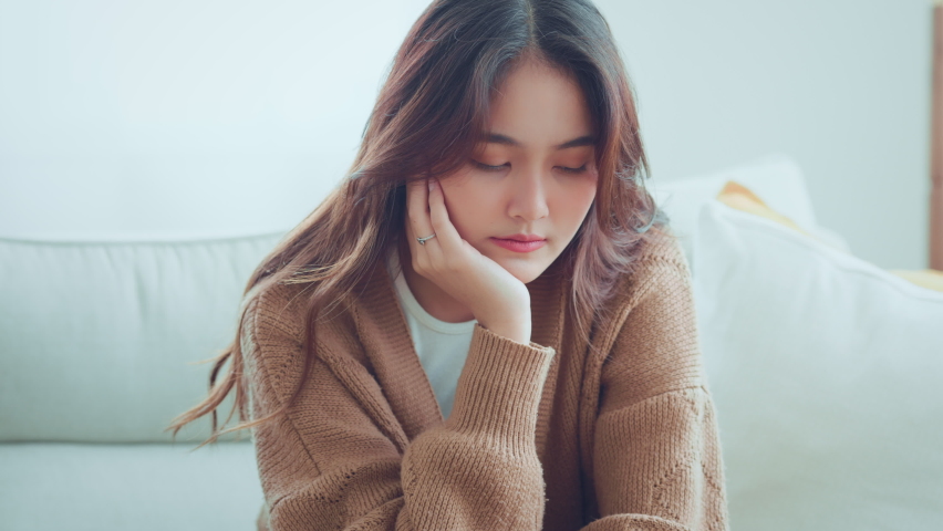 Sad tired young asian woman touching forehead having headache migraine or depression, upset frustrated girl troubled with problem feel stressed, Grief sorrow concept Royalty-Free Stock Footage #1092181575