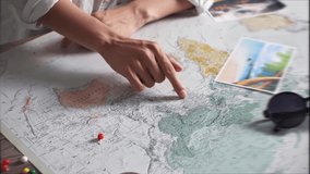 Tourist vacation planning with help world map with tourist accessories around. Young woman pointing finger route from India to Nepal world map. Tourist looks at world map. Near markers for waypoints
 - Powered by Shutterstock - Get 15% off with code: PIKWIZARD15
