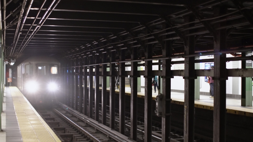 New York City, USA - 12. November 2021: One Train approaching Subway Station in Manhattan. MTA Subway train in station. Red Line