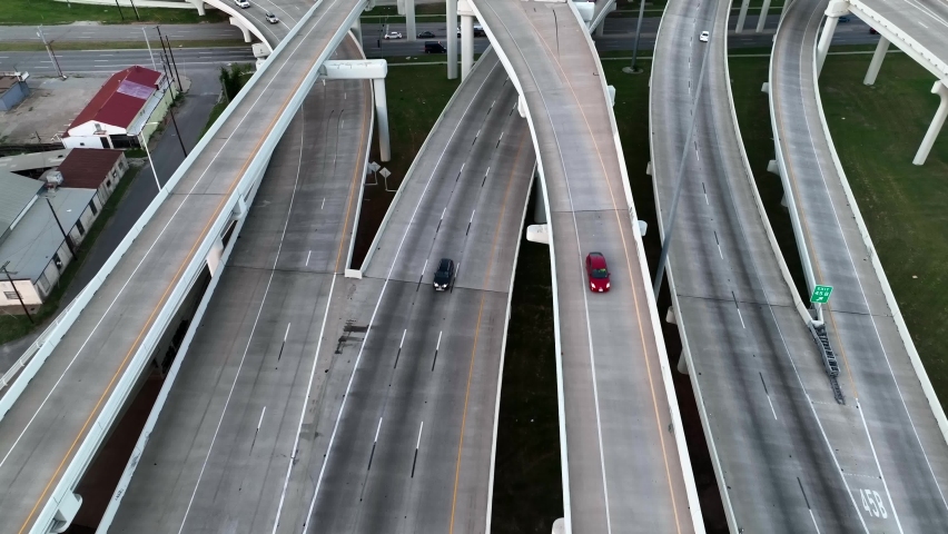 Dallas Texas skyline aerial tilt up reveal. Drone flight above interstate highway in TX USA.