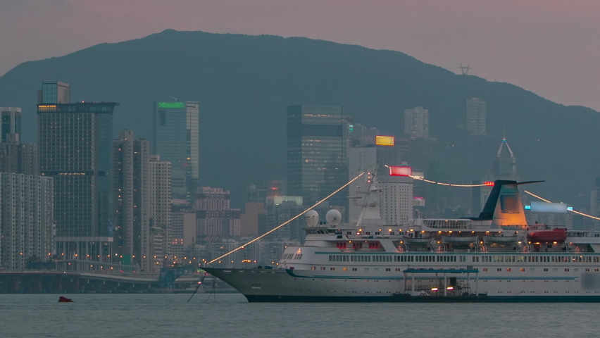 Hong Kong from day to night transition, view from kowloon bay downtown timelapse with cruise ship and modern towers on background