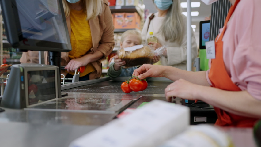 A checkout counter cashier scans vegetable in supermarket. Royalty-Free Stock Footage #1092211347