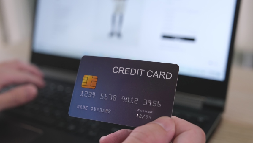 Men hand holding credit card and type payment information on keyboard for order online shopping. Internet technology and Digital market place E-Commerce lifestyle concept, Purchase transaction. | Shutterstock HD Video #1092213423
