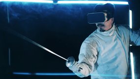 Male athlete is wearing VR-glasses and practicing fencing