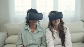 Holiday concept of 4k Resolution. Asian women use vr together in the living room. virtual reality technology.