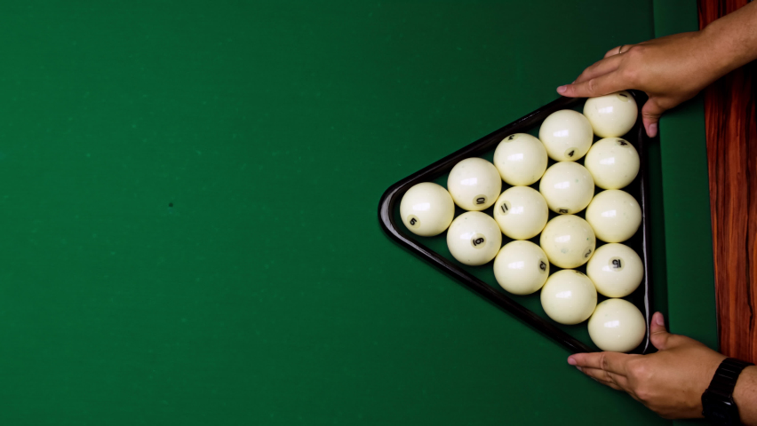 Men hands place pyramid of white balls with help of triangle on billiard table and they are beaten by red ball. Playing Russian billiards, top down frame on balls and green table. | Shutterstock HD Video #1092222397