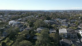 Aerial view of residential neighborhood in the autumn with ocean in the horizon