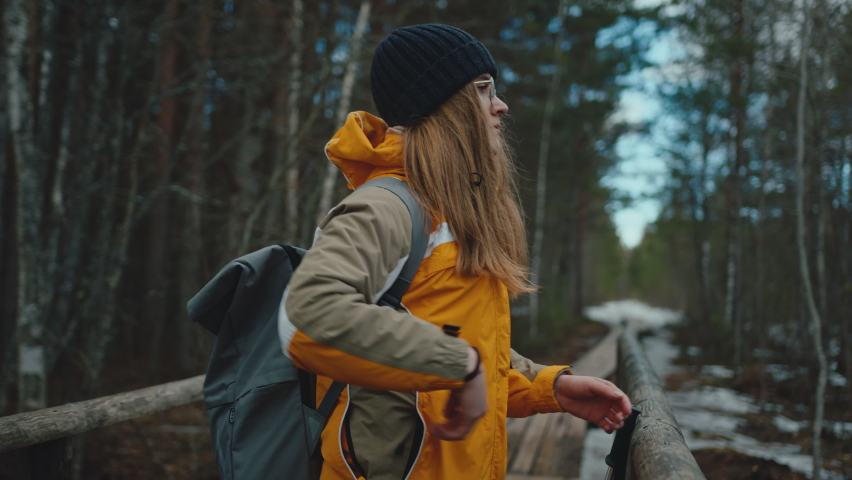 Female hiker enjoys forest view then walks away, slow motion