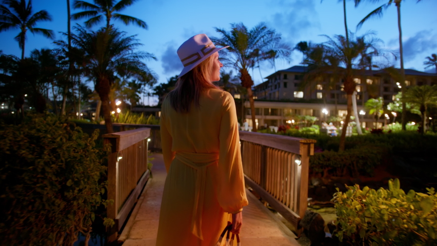 Elegant traveler woman in yellow dress at luxury resort garden. Tourists in tropical SPA hotel. Travel Hawaii island, USA tourism, beach vacation, happy holidays, honeymoon slow motion RED shot Royalty-Free Stock Footage #1092230309