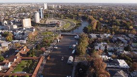 Tigre residential area in Buenos Aires province with cityscape and Parana river and cars crossing bridge, Argentina. Aerial drone pov