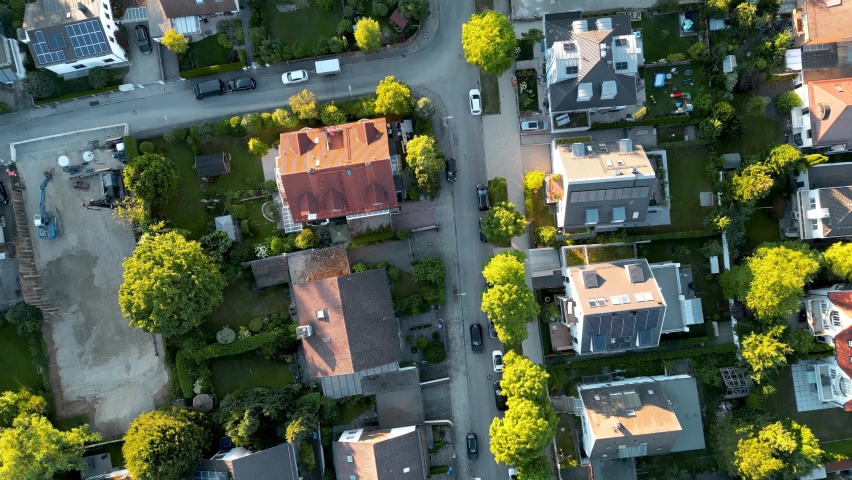 Birdseye aerial view suburban munich. drone flying top down over middle class family houses with small garden in europe. Edge of city residential area popular for young families.