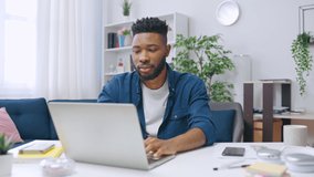 Smiling African American man working from home, studying online during covid-19 - Powered by Shutterstock - Get 15% off with code: PIKWIZARD15