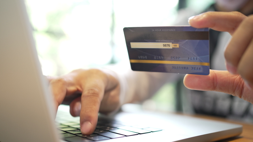 Close up hand man using laptop computer with credit card e-commerce shopping online and making internet banking | Shutterstock HD Video #1092237629