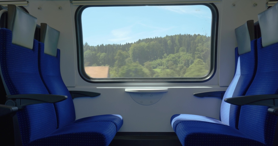 Moving train with empty seats or bench. Inside view, moving landscape out the windows, real time, no people. Swiss SBB public train in Europe Royalty-Free Stock Footage #1092240635
