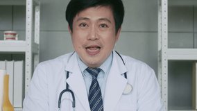 Asian male Physician is Making Conference Video Call with a Patient.