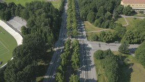 Drone video of green street design with tram tracks in Helsinki, Finland. Public transportation and urban cityscape in Europe.