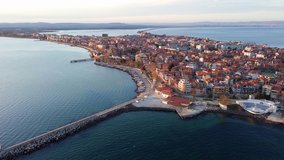 Bird's eye view of the small historical town of Nessebar with a small maritime yacht pier located on a peninsula in a calm, quiet, deep Black Sea, Bulgaria