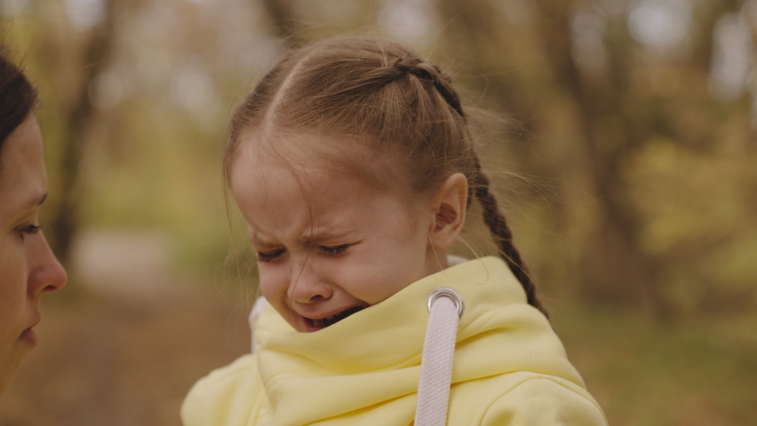 child crying. close-up face. tears eyes little kid girl. unhappy upset child. mother calms child daughter. feeling pain face tearful, capricious child. wet tears run down cheek little frustrated kid Royalty-Free Stock Footage #1092255623
