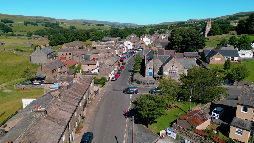 Drone, ariel view of Hawes a small rural market town and civil parish in the Richmondshire district of North Yorkshire, England. Royalty-Free Stock Footage #1092258383