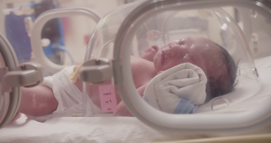 Closeup little newborn baby infant in incubators for newborns, Newborn baby having the the breathing problem after birth, newborn in NICU, Neonatal intensive care unit, healthcare Royalty-Free Stock Footage #1092260325