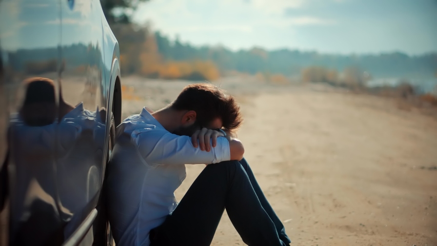 Sad Disappointed Man Sitting On Broken Car. Sad Exhausted Businessman. Confused Annoyed Tired Stressful Situation. Disappointed Problems Man On Car. Overworked Stressed Businessman Fired From Work Royalty-Free Stock Footage #1092262363