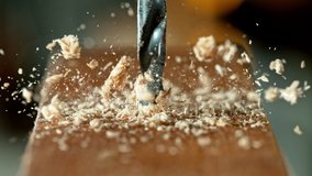 Super slow motion of detail of a drill bit drilling into wood. Filmed on high speed cinema camera, 1000 fps. - Powered by Shutterstock - Get 15% off with code: PIKWIZARD15