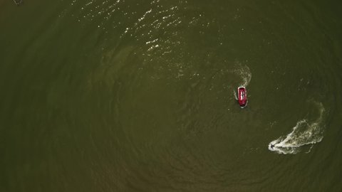 video from a copter, a red boat and a flyboard on the reservoir