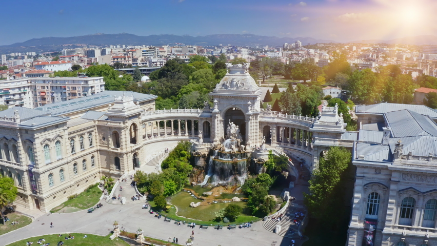 Longchamp palace park complex historical construction of classic architecture touristic place with fountain royal fortress in french town Marseille aerial panoramic view in sunlight from flying drone