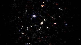 Wide field video of the deepest universe. Zooming into thousands of galaxies in a tiny sliver of the vast universe. Fly towards extremely distant galaxies revealing the view of the early universe.