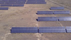 Aerial video shooting of a power plant using alternative energy sources. Farm solar panels. Alternative energy source. Green energy, preservation of ecology and rejection of hydrocarbons.