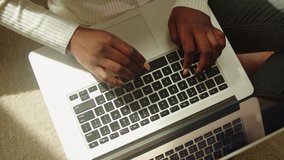 Native African American woman using laptop top view. Young female student working remotely at computer in living room, freelancer. Remote work. Communicating with friends via internet. - Powered by Shutterstock - Get 15% off with code: PIKWIZARD15