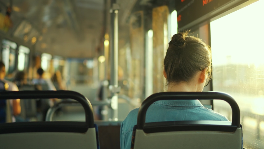 Woman in tram using smartphone chatting and texting with friends, back view. City, urban, transportation. Slow motion Royalty-Free Stock Footage #1092306119