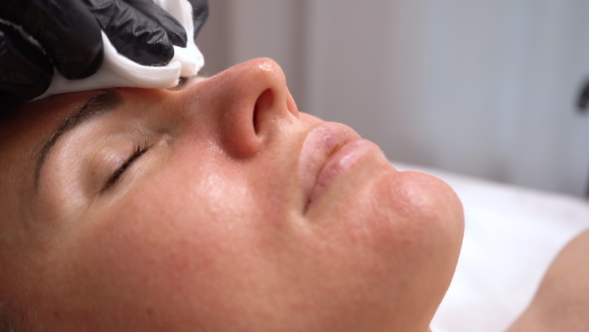 Moisturizing rejuvenation facial peeling mask. Cosmetology beauty spa. Close-up.