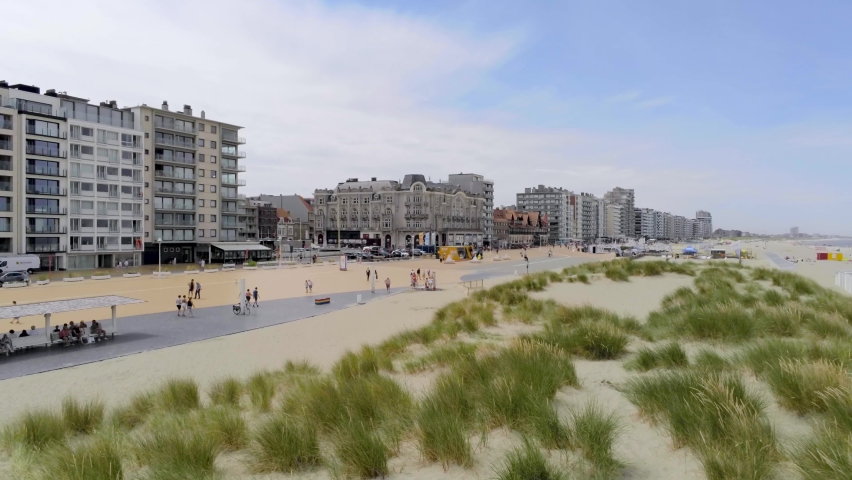 People walk and enjoy in summertime in scenery town near the Belgian beach, Nieuwpoort, Belgium