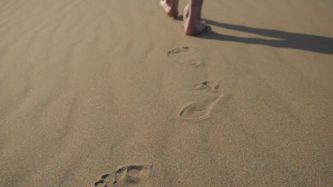 closeup footage of footprints on sand. human footprints. the ecological footprint. human impact on nature.