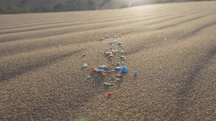 pieces of microplastic on sand. primary and secondary microplastics. small pieces of plastic. soil contamination, marine plastic pollution, environment, ecology, earth Royalty-Free Stock Footage #1092324451