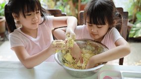 Daughter hands preparing dessert at home together. Cooking activity for children learn to participate in family.