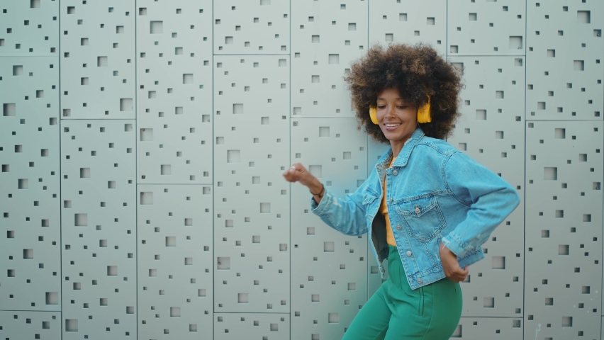 Beautiful young woman with curly hair having fun and doing activities outdoor in Paris. Concept about people and lifestyle