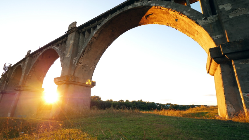 Female sports tourist is passing by a deserted bridge