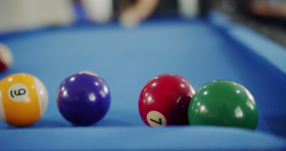 Close up person enjoying playing billiard break shot Pool Balls with numbers on a pool table, Sports game of billiards	 | Shutterstock HD Video #1092330285