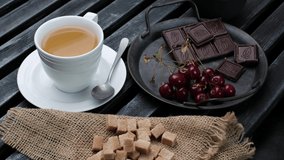 Tea with chocolate and brown sugar. Close-up 4k video shooting, dark background