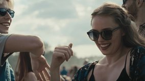 Young caucasian friends dancing on music festival with hands up. Shot with RED helium camera in 8K.  - Powered by Shutterstock - Get 15% off with code: PIKWIZARD15