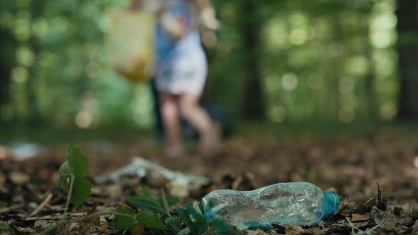 Close up of plastic bottle in forest which taken by boy with family. Shot with RED helium camera in 4K.     | Shutterstock HD Video #1092349515