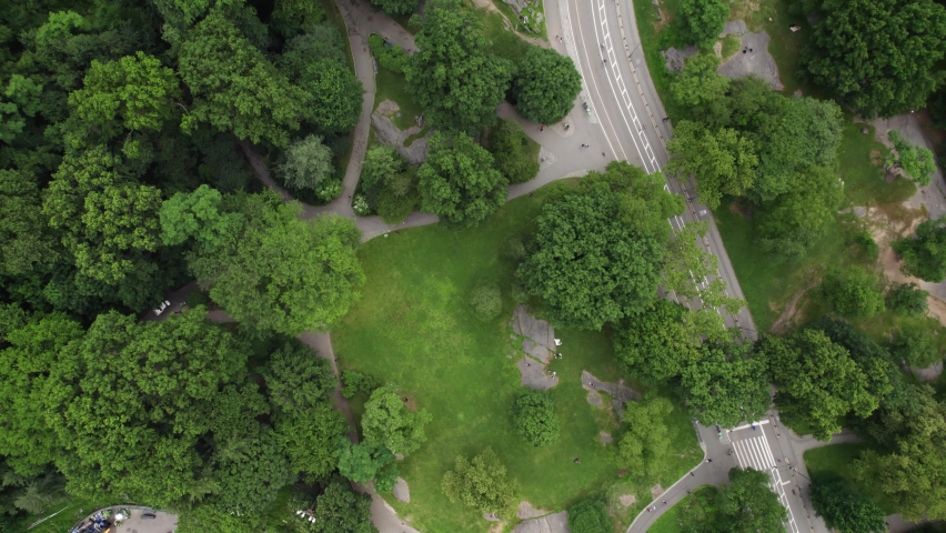 Aerial view above a road in Central Park, summer in cloudy New York, USA - rotating, top down, drone shot Royalty-Free Stock Footage #1092353469