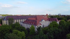 Daring aerial view flight fly backwards drone footage of Prussian State Archives of Cultural Heritage dahlem Berlin, golden hour Summer 2022. Cinematic view from above Tourist Guide by Philipp Marnitz